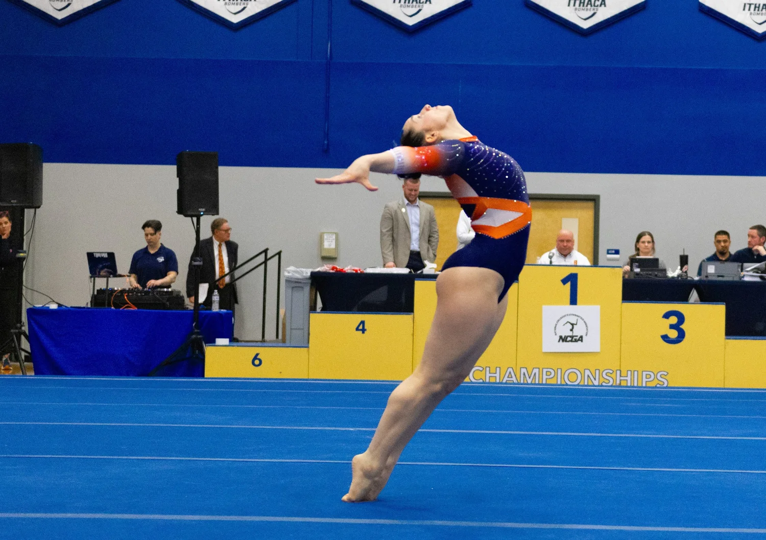 Photo of a Utica college gymnast performing on floor.